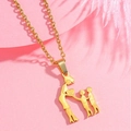 Detail of gold family necklace featuring a mother and two children silhouette pendant - Mom + 2 Sons
