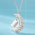 Macro shot of silver sister moon and heart pendant necklace with love quote engraving - Sister (Style 1)