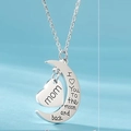 Macro detail of crescent moon and heart pendant engraved with I love you to the moon and back - Mom (Style 2)