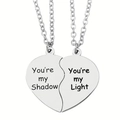 Detail view of puzzle heart necklaces with engraved You're my Shadow and Light text - Shadow & Light Emotional Style (Style 4)