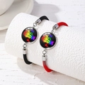 Detail of woven rainbow pride bracelets in black and red with metal charm - Rainbow Colored Fist PRIDE Design (Style 6)