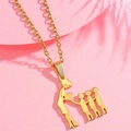 Close-up of golden family silhouette necklace on a soft pink feather background - Gold Three Sons Silhouette