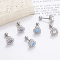 Nahaufnahme von 18k Edelstahl Herz-Ohrsteckern mit lila und blauen Zirkonia-Steinen - Violetter Zirkonia / Silber