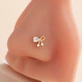 Macro detail of golden butterfly nose stud with micro-paved cubic zirconia gems - Bow Design (7#) / Gold