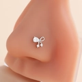 Silver bow nose stud with micro-pave zircons on a silicone display model - Bow Design (7#) / Silver
