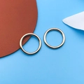 Set of two polished silver finish metal rings with a smooth reflective mirror surface - Circle Link Style