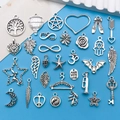 Set of 28 vintage silver alloy charms with mixed shapes on bright blue background - Antique Silver Mixed Style Set