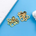 Golden octopus alloy charms with intricate hollow design on light blue background - Antique Gold Marine Octopus (7984)