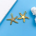 Pair of golden alloy starfish pendants with marine texture on a light blue background - Antique Gold Starfish (10220)