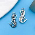 Antique silver mermaid charms for DIY jewelry making on a light blue background - Mermaid Style (8756)