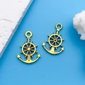 Golden alloy rudder and anchor pendants on blue nautical background for DIY jewelry - Antique Gold Anchor Helm (10227)