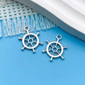 Silver nautical ship wheel charms for DIY jewelry making on a light blue background - Antique Silver Round Small Ship Wheel (5581) / 15x20mm