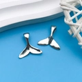 Pair of antique silver whale tail alloy charms for DIY necklaces on blue background - Antique Silver Whale Mermaid Tail 15x16mm (8750)