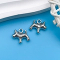Pair of silver-tone Scottish Terrier charms for DIY jewelry making on blue background - Antique Silver Line Dog 12x14mm (9809)