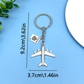 Silver metal travel keychain with plane and passport pendant, size 9.2cm by 3.7cm - Plane Passport (ER680)