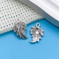 Vintage silver alloy leaf charms for DIY jewelry with detailed vein texture on blue background - Antique Silver Leaf
