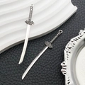 Detail of silver alloy sword pendants with intricate vintage engravings for DIY jewelry - Antique Silver Sword Style