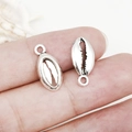 Antique silver shell charm pendant for DIY jewelry making shown held between fingers - Antique Silver Sea Shell (8x18mm-11296)