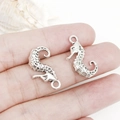 Antique silver seahorse charm in zinc alloy, hand-held for scale with ocean theme - Antique Silver Seahorse (15x22mm-16312)