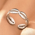 Detailed macro view of silver adjustable ring with shell texture on beige fabric - Silver Shell (C1494)