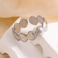 Detailed view of silver scalloped shell ring on white stone, adjustable metal jewelry - Shell Design Style (25) / Steel
