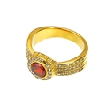 Macro shot of 18k gold plated ring featuring a large red zircon stone and small clear crystals - Gold Red Zirconia
