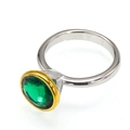 Detail of round emerald green gemstone with gold bezel on silver stainless steel ring - Two-tone Gold Silver Green Zircon