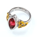Detailed side view of vintage titanium steel ring with red gemstone and golden celtic knots - 7 / Two-tone Gold Fuchsia