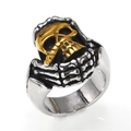 Gothic punk style skull ring with silver skeletal hand gripping a golden skull head - US 7 / Gold & Silver