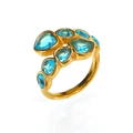 Detail shot of a gold-plated ring featuring multi-faceted blue cubic zirconia stones - Gold Aqua Blue Zirconia