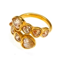 Macro shot of gold-plated cross-over ring featuring six heart-shaped zircon stones - US 6 / Gold Champagne Stone