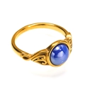 Macro shot of vintage gold steel ring with intricate hollow floral patterns and blue stone - US 6 / Gold Blue