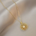 Elegant gold necklace with hollow starburst pendant and sparkling central zircon stone - Round Style