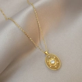 Golden oval starburst pendant necklace with a central zircon and fine chain - Ellipse