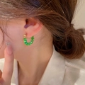 Green bead C-shaped titanium steel hoop earrings worn by a model in casual style - Irregular C-Shape (KO-754) / Green Cat's Eye