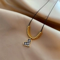 Minimalist black cord necklace with checkered heart pendant on silk background - Gold Heart (Black and White Checkerboard)