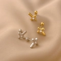 Close-up of X-shaped cross earrings with zircon stones and secure screw-back ball closures - Rhinestone Cross Spiral Stud / Steel