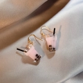 Detail of pink milk tea dangle earrings with black boba pearls and gold alloy hooks - Pink