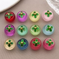 Macro view of 12 colorful glass clover charms with golden base for DIY jewelry making - Multi-Color Assortment