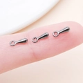 Three gunmetal black teardrop metal charms for DIY jewelry making shown on finger - 7x2.5mm / Gunmetal