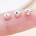 Silver copper crimp beads and round cylinder spacers held on fingertip for DIY jewelry - Flat / 4.5x3mm Hole 1mm / Bright Silver