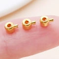Golden round copper slider beads for DIY jewelry making shown on a fingertip - Flat / 4.5x3mm Hole 1mm / Imitation Gold