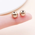 DIY jewelry making small round gold plated spacer beads held on a fingertip for size - Round (14076) / 1 Piece/Pack (8mm) / KC Gold