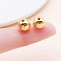 Close-up of small golden CCB beads on finger for DIY jewelry making and crafting - Round (14078) / 1 Piece/Pack (8mm) / Gold