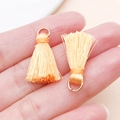 Mini orange tassels with gold metal loops for DIY jewelry and backpack charm accessories - Bronze