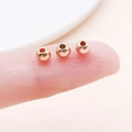 Drei 2-3mm roségoldene Metall-Zwischenperlen auf der Fingerspitze für DIY Schmuck - Runde Abstandsperle (14149)