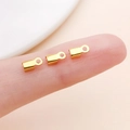 Three gold-plated iron cord end clamps for jewelry making held by fingers - Gold Smooth Style