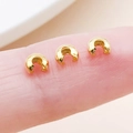 Three golden plated crescent moon crimp covers held on fingertips for size reference - Gold - Small