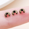 Antique bronze crimp bead covers on a finger showing small size for DIY jewelry - Bronze - Small