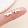 Silver metal end crimp caps for jewelry cords held on fingertip for scale - Bright Silver Large Style with Points